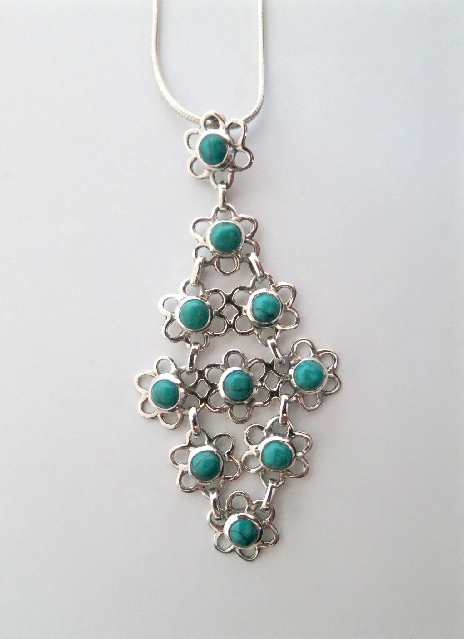 Chic and artistic, Samarkand linked floral units flexible turquoise pendant
