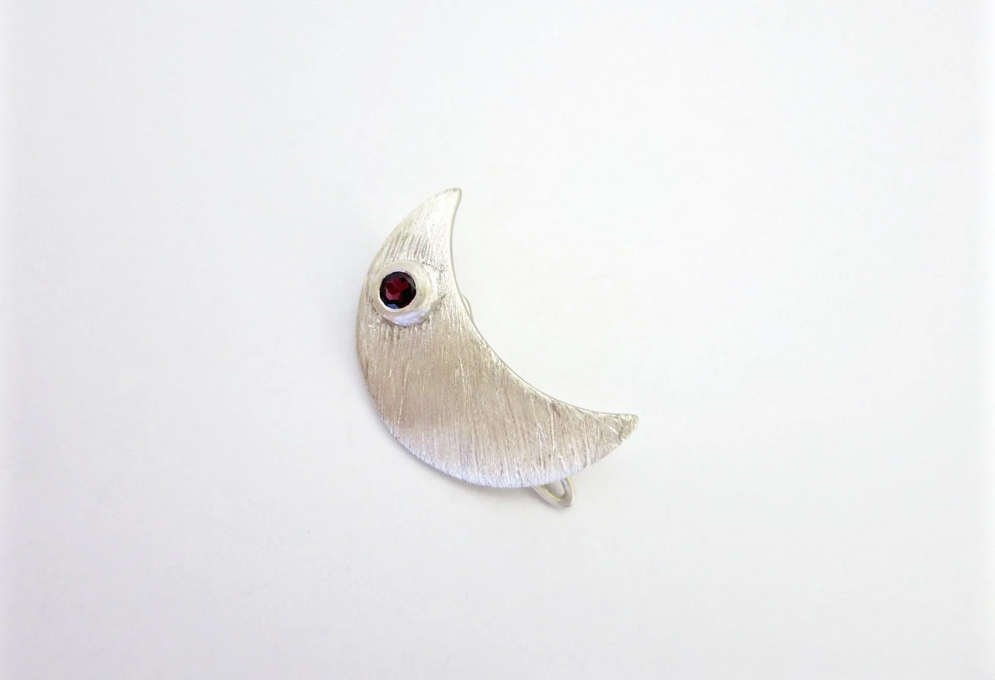 Chic crescent shape hair clip, accented with garnet